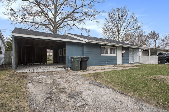 view of front facade with asphalt driveway and a front yard