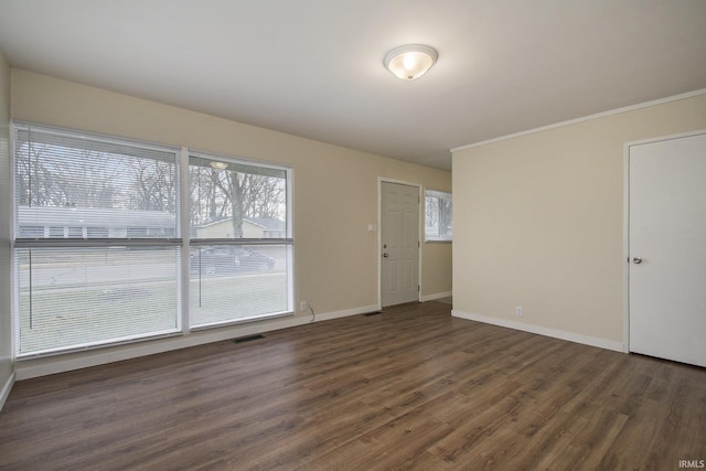 spare room with wood finished floors and baseboards