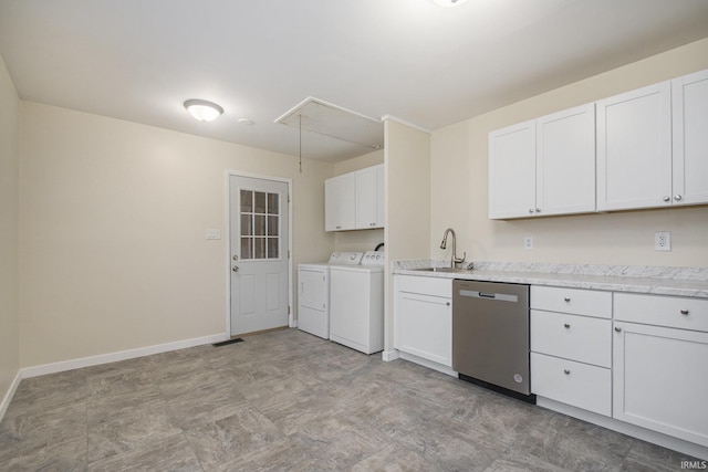 laundry room with washer and dryer, attic access, a sink, baseboards, and light flooring