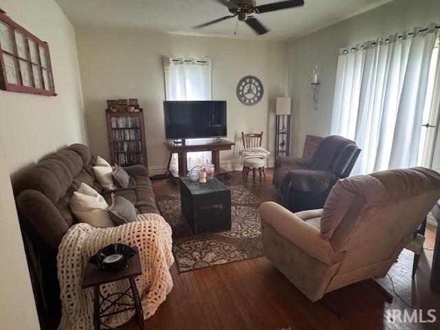 living area featuring wood finished floors and a ceiling fan