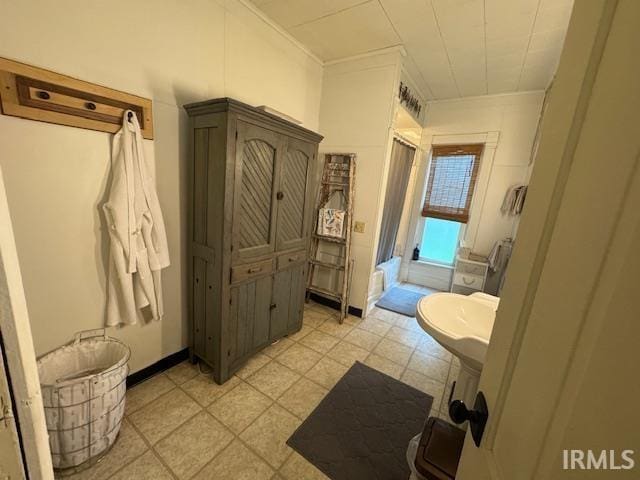 bathroom with ornamental molding and tile patterned flooring