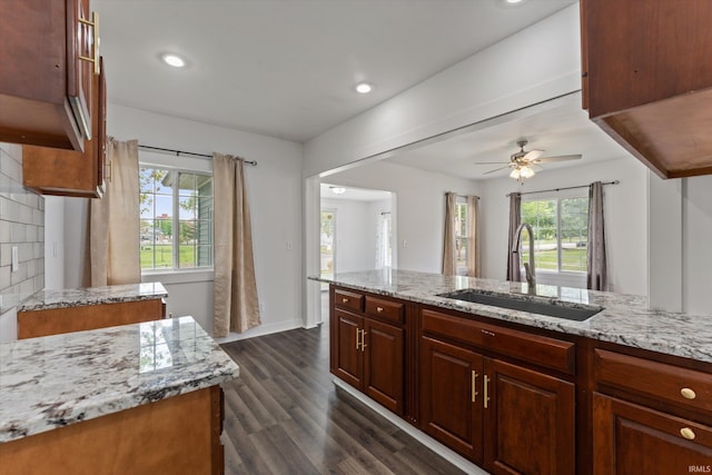 kitchen featuring a sink, light stone countertops, dark wood-style flooring, ceiling fan, and recessed lighting