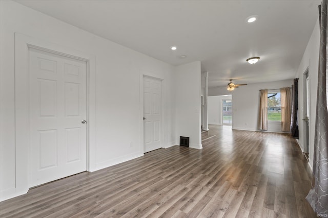 unfurnished living room with wood finished floors, ceiling fan, recessed lighting, and baseboards