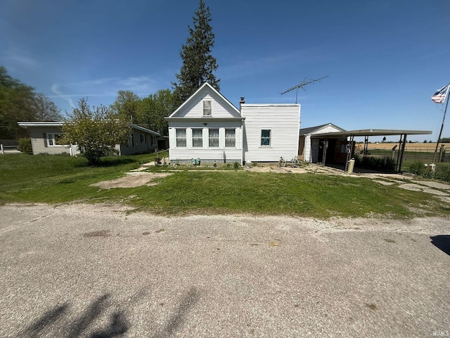 rear view of house with a lawn