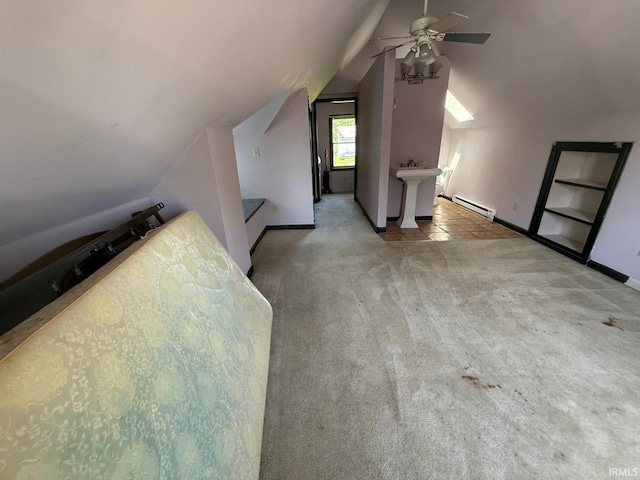 additional living space featuring a baseboard heating unit, lofted ceiling, ceiling fan, carpet, and baseboards
