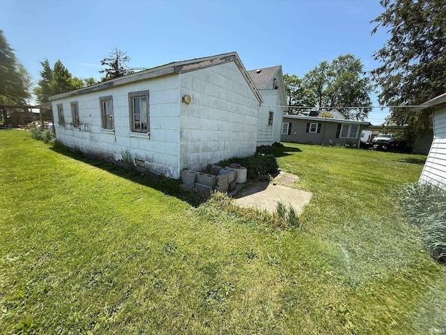 view of side of property with a yard