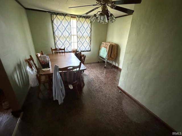 dining room with ceiling fan and baseboards