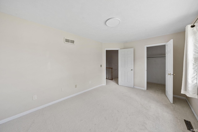 50880 Cherry Farm Trl, Granger, IN 46530 - unfurnished bedroom featuring light colored carpet, baseboards, a walk in closet, and a closet