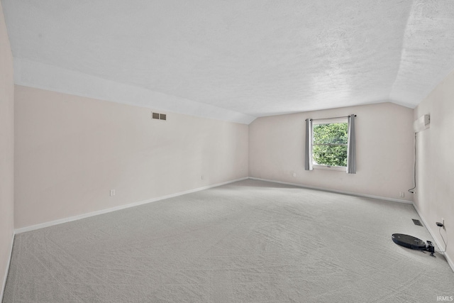 50880 Cherry Farm Trl, Granger, IN 46530 - unfurnished room with lofted ceiling, carpet floors, a textured ceiling, and baseboards