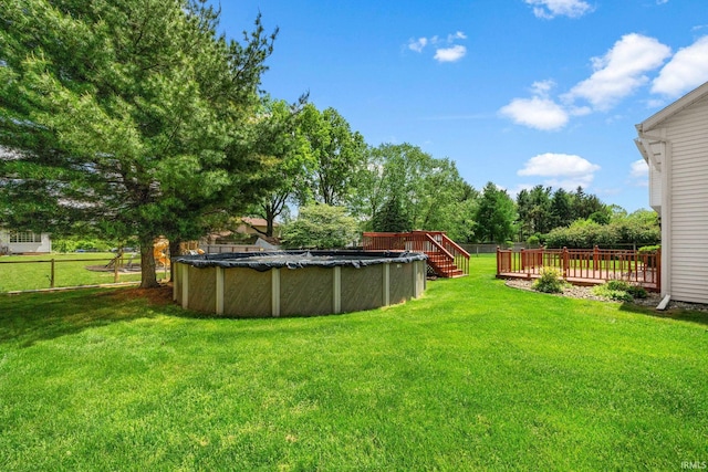 50880 Cherry Farm Trl, Granger, IN 46530 - view of yard with a wooden deck and a covered pool