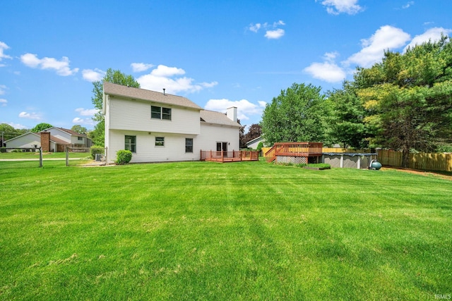 50880 Cherry Farm Trl, Granger, IN 46530 - rear view of house featuring a deck, an outdoor pool, and a chimney