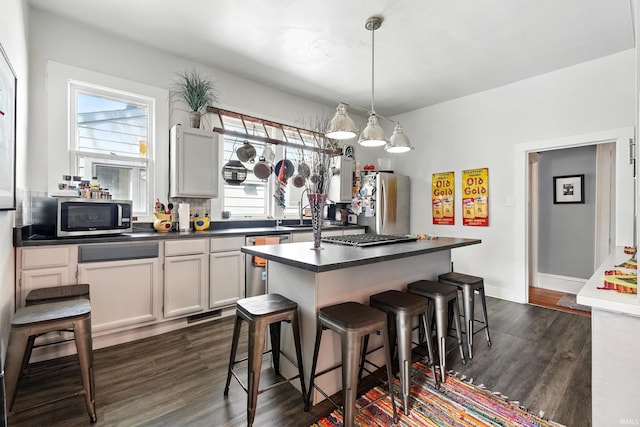 1021 W Wayne St, Fort Wayne, IN 46802 - kitchen featuring stainless steel appliances, dark countertops, and dark wood-style floors
