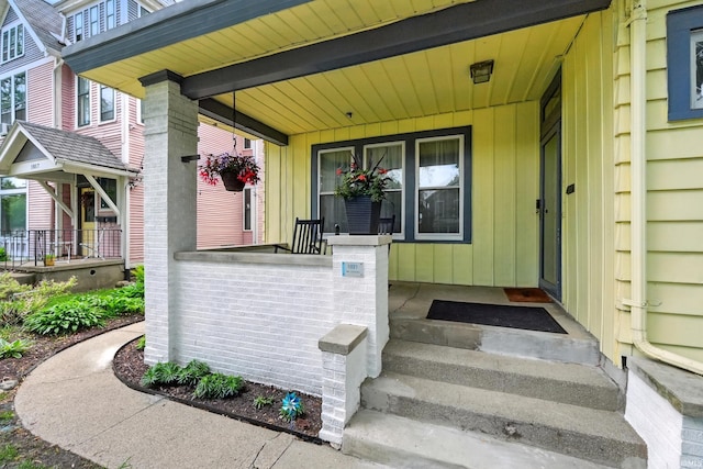 1021 W Wayne St, Fort Wayne, IN 46802 - doorway to property with covered porch and board and batten siding