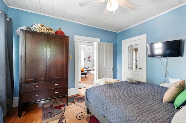1021 W Wayne St, Fort Wayne, IN 46802 - bedroom with crown molding, light wood-style floors, and ceiling fan