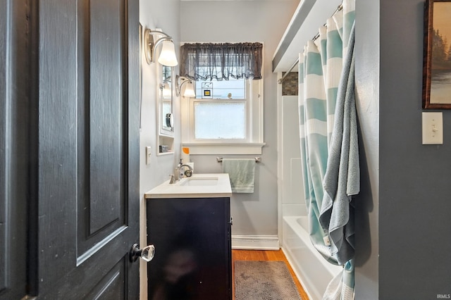 1021 W Wayne St, Fort Wayne, IN 46802 - bathroom with wood finished floors, vanity, and shower / tub combo