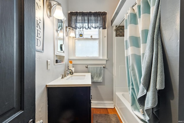 1021 W Wayne St, Fort Wayne, IN 46802 - full bath featuring wood finished floors, vanity, and shower / tub combo