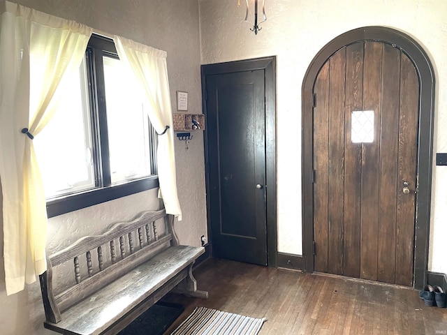 216 W 3rd St, Peru, IN 46970 - entrance foyer featuring wood-type flooring, a textured wall, and arched walkways