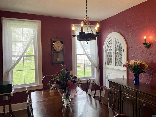 216 W 3rd St, Peru, IN 46970 - dining room with a chandelier, a textured wall, plenty of natural light, baseboards, and wood finished floors