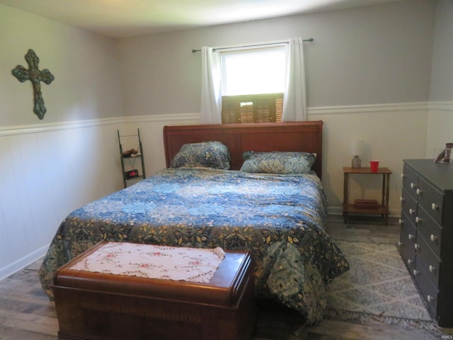 1243 Bellgrade Ave, Loogootee, IN 47553 - bedroom featuring wood finished floors and wainscoting