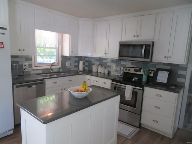 1243 Bellgrade Ave, Loogootee, IN 47553 - kitchen with stainless steel appliances, a sink, dark countertops, and white cabinets