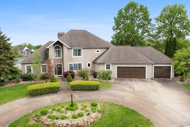 traditional-style home with curved driveway, a chimney, a garage, a front yard, and a shingled roof