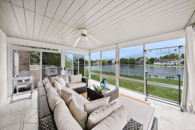sunroom with a water view, an outdoor hangout area, and a ceiling fan