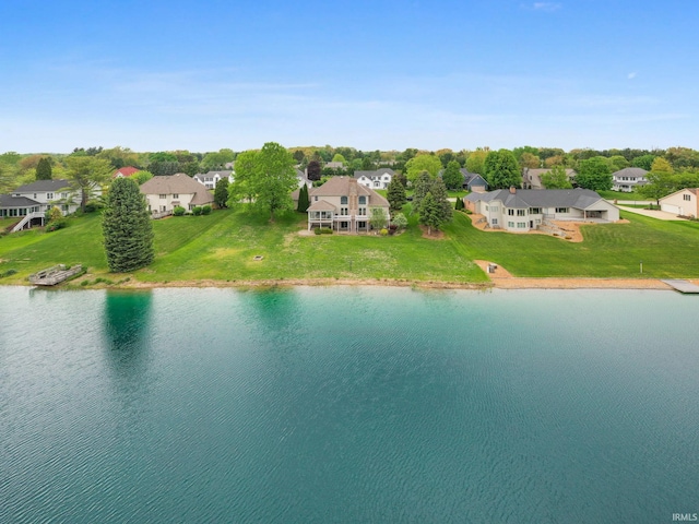 aerial view of residential area featuring a large body of water