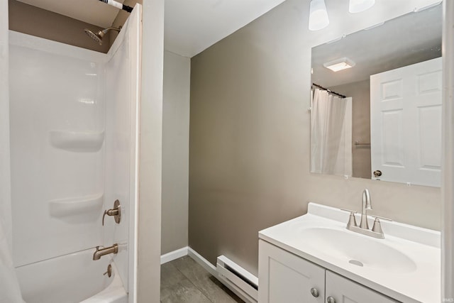 1317 W Tate St, Kokomo, IN 46901 - full bath with baseboard heating, vanity, baseboards, shower / tub combo with curtain, and wood finished floors