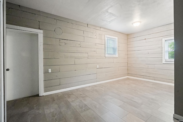 1317 W Tate St, Kokomo, IN 46901 - empty room featuring wooden walls, wood finished floors, and baseboards