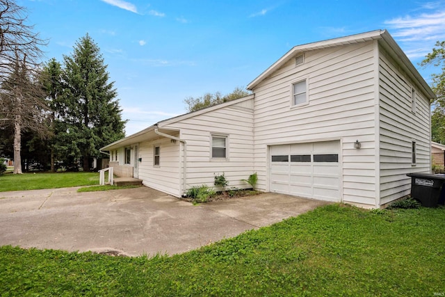 1317 W Tate St, Kokomo, IN 46901 - view of side of home featuring a garage, a lawn, and driveway