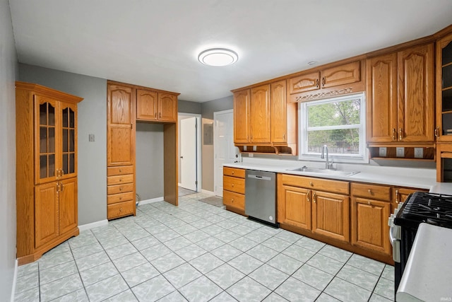 1317 W Tate St, Kokomo, IN 46901 - kitchen with stainless steel appliances, a sink, brown cabinetry, and light countertops