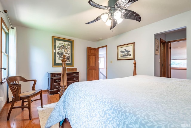 bedroom with wood finished floors, ceiling fan, and baseboards