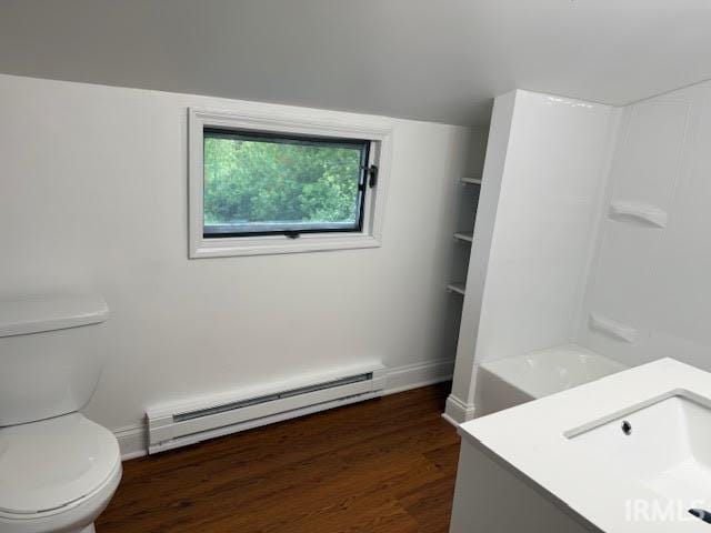 bathroom with a baseboard radiator, wood finished floors, toilet, and vanity