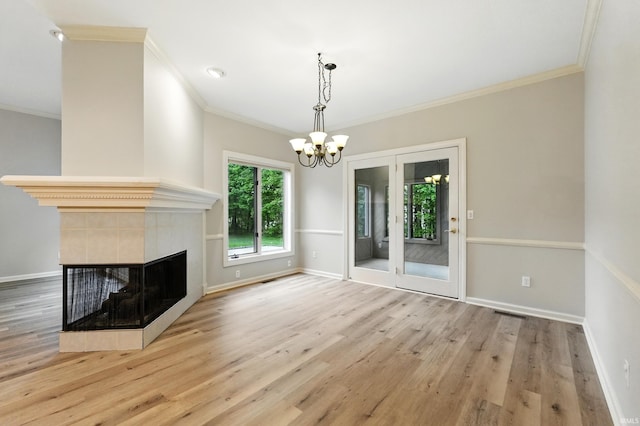 12908 Chaplin Ct, Fort Wayne, IN 46845 - unfurnished living room featuring a chandelier, crown molding, wood finished floors, baseboards, and a tiled fireplace