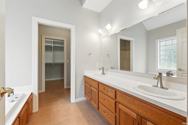 12908 Chaplin Ct, Fort Wayne, IN 46845 - full bath featuring double vanity, tile patterned flooring, a spacious closet, a tub, and baseboards