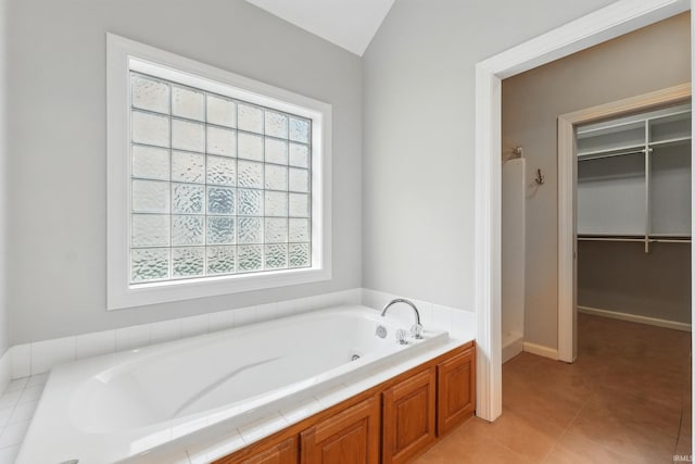 12908 Chaplin Ct, Fort Wayne, IN 46845 - full bathroom featuring healthy amount of natural light, a garden tub, a spacious closet, tile patterned floors, and vaulted ceiling