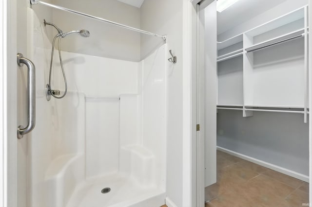 12908 Chaplin Ct, Fort Wayne, IN 46845 - full bathroom with a stall shower, tile patterned flooring, a spacious closet, and baseboards