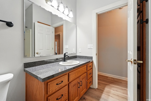 12908 Chaplin Ct, Fort Wayne, IN 46845 - bathroom featuring wood finished floors, toilet, and vanity