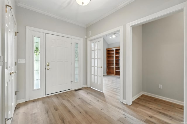 12908 Chaplin Ct, Fort Wayne, IN 46845 - foyer featuring crown molding, light wood-style floors, healthy amount of natural light, and baseboards