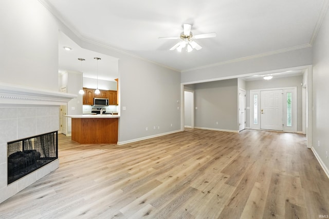 12908 Chaplin Ct, Fort Wayne, IN 46845 - unfurnished living room with light wood-style flooring, ceiling fan, ornamental molding, baseboards, and a fireplace