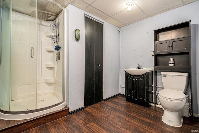 56635 N Wedgewood Ave, Elkhart, IN 46516 - full bathroom featuring wood finished floors, a stall shower, toilet, vanity, and a paneled ceiling