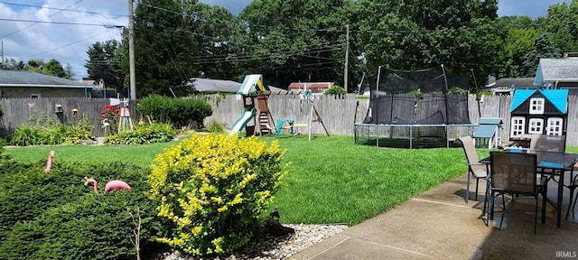56635 N Wedgewood Ave, Elkhart, IN 46516 - view of yard featuring a trampoline, a playground, a patio, and outdoor dining space