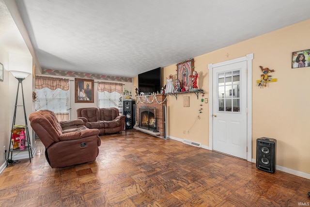 56635 N Wedgewood Ave, Elkhart, IN 46516 - living area featuring baseboards, a brick fireplace, and a textured ceiling