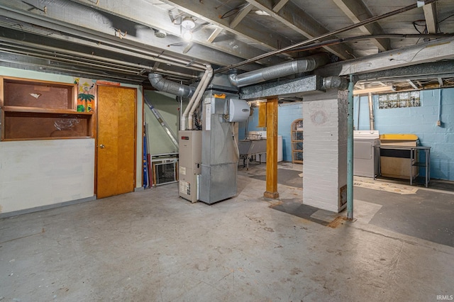 unfinished basement with washer / dryer and heating unit