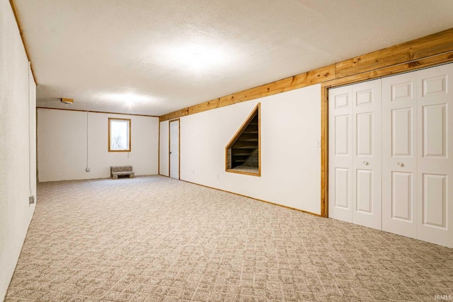 basement with carpet floors and a textured ceiling