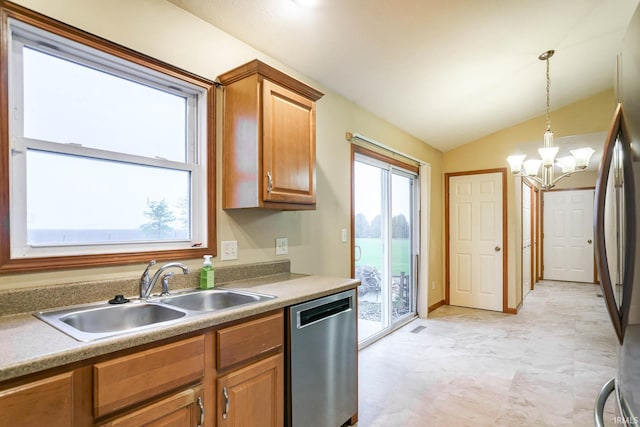kitchen with stainless steel appliances, a sink, a chandelier, pendant lighting, and lofted ceiling