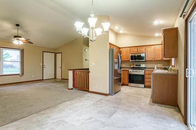 kitchen featuring stainless steel appliances, vaulted ceiling, open floor plan, ceiling fan, and brown cabinets