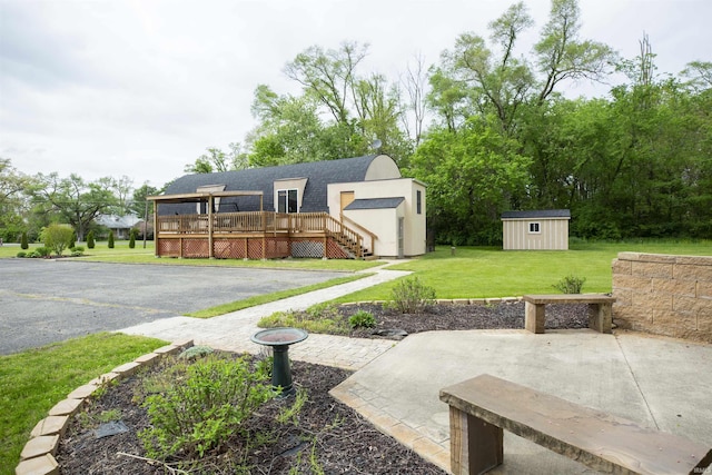 59000 Crumstown Hwy, North Liberty, IN 46554 - view of grassy yard featuring a shed, a deck, an outdoor structure, and a patio