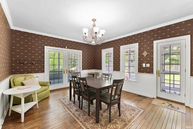 14612 Liberty Mills Rd, Fort Wayne, IN 46814 - dining area with hardwood / wood-style flooring, plenty of natural light, wainscoting, a chandelier, and wallpapered walls