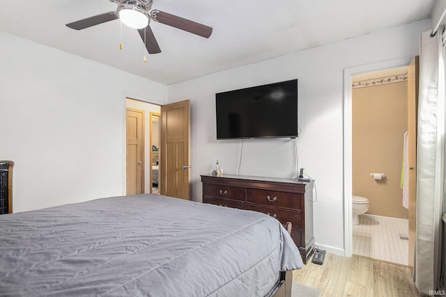 1612 W Grant St, Bremen, IN 46506 - bedroom featuring ensuite bath, ceiling fan, baseboards, and light wood-style floors